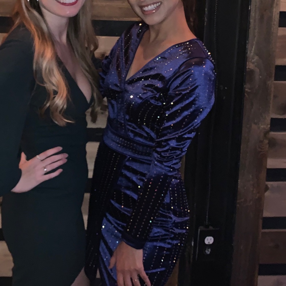 Long-sleeve, satin dress covered in rhinestones.